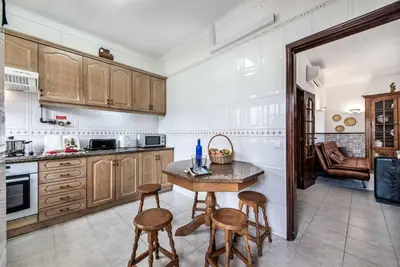 a kitchen with a table and some chairs in it at Villa Torcato in Albufeira