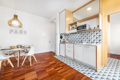 a kitchen and dining room with a table and chairs at RG Downtown Duplex in Faro