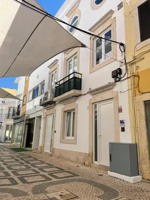 a tv sitting on the side of a building at RG Downtown Duplex in Faro