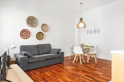 a living room with a couch and a table at RG Downtown Duplex in Faro