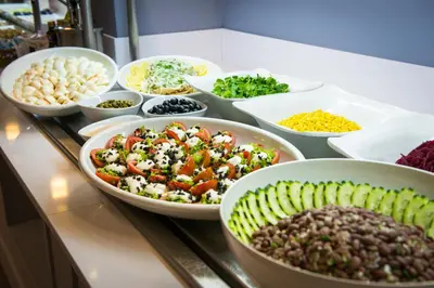 a buffet with bowls of different types of food at 3HB Clube Humbria - All Inclusive in Albufeira