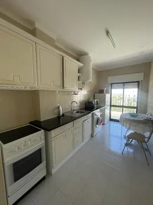 a living room with a bed and a table at Apartamentos Carteia in Quarteira
