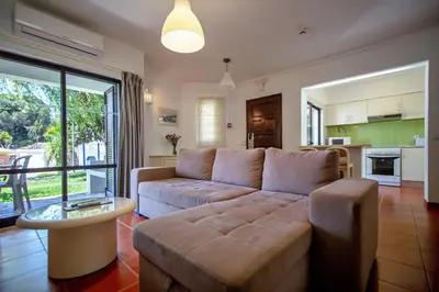 a living room with a couch and a table at Clube Albufeira Garden Village in Albufeira