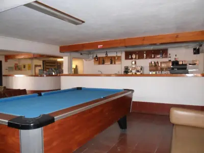 a pool table in a room with a bar at Aldeia Da Falesia in Albufeira