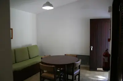 a living room with a table and a green couch at Aldeia Da Falesia in Albufeira