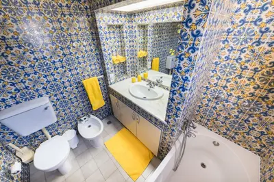 a bathroom with a toilet sink and a mirror at 60m2 Lovely traditional apartment in Clube Albufeira in Albufeira