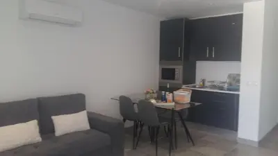 a living room with a couch and a table with chairs at Orange Studio in Vilamoura