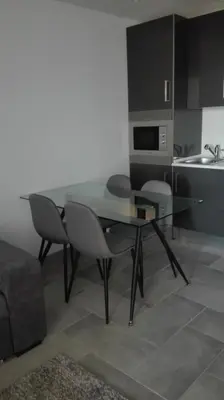 a dining room table and chairs in a kitchen at Orange Studio in Vilamoura