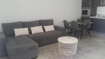 a living room with a couch and a table at Orange Studio in Vilamoura