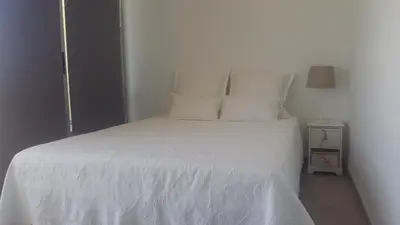 a white bed with white sheets and pillows at Orange Studio in Vilamoura