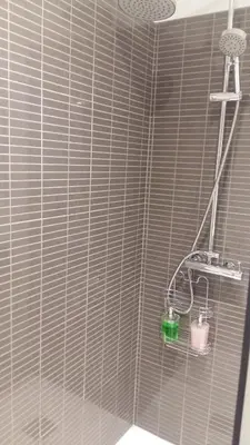 a shower in a bathroom with a shower head at Orange Studio in Vilamoura