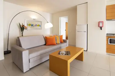 a living room with a couch and a table at The Navigator - Olympus Marina in Vilamoura