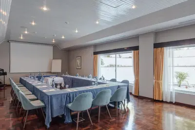a large meeting room with a long table and chairs at Dona Filipa Hotel in Vale do Lobo