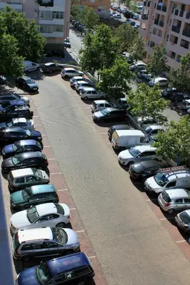 a row of cars parked in a parking lot at Sweet Dream House in Faro