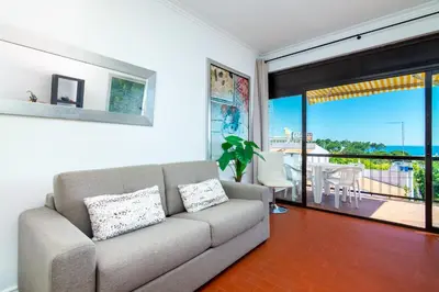 a living room with a couch and a balcony at WHome | Albufeira Suite & Beach Apartment in Albufeira