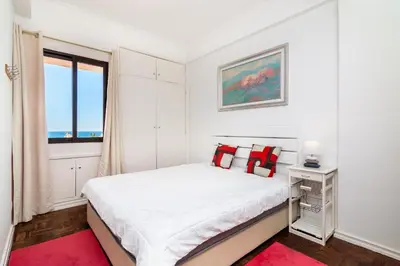 a white bedroom with a bed and a window at WHome | Albufeira Suite & Beach Apartment in Albufeira