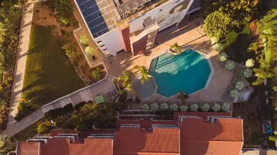 a pink flamingo float in a swimming pool at Topazio Vibe Beach Hotel & Apartments - Adults Friendly in Albufeira