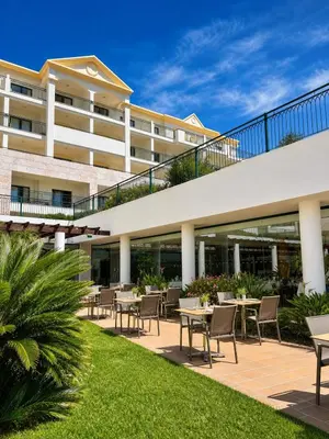 a balcony with tables and chairs and a view of the city at Cerro Mar Atlantico & Cerro Mar Garden in Albufeira