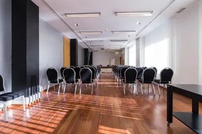 a gym with treadmills and cardio equipment in a building at Hotel Quarteirasol in Quarteira