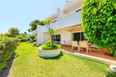 a backyard of a house with a patio at Victory Village 2A in Quinta do Lago