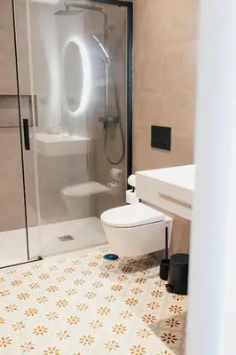 a bathroom with a shower and a toilet and a sink at Vila Channa - Adults Only in Albufeira