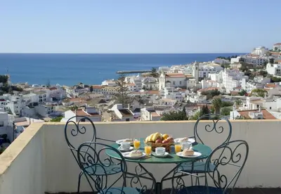 a table with a bowl of fruit on a balcony at Alfagar Cerro Malpique in Albufeira