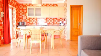 a kitchen with a table and chairs in a room at Alfagar Cerro Malpique in Albufeira