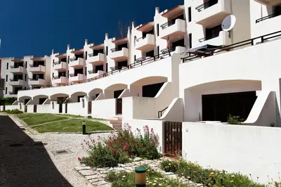 an external view of a building with a courtyard at Albufeira Jardim by Umbral in Albufeira