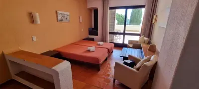 a living room with a bed and a couch at Albufeira Jardim by Umbral in Albufeira