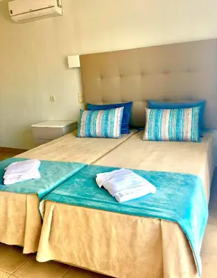 a bedroom with two beds with towels on them at Albufeira Jardim by Umbral in Albufeira
