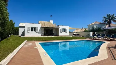 a swimming pool in front of a house at Galo by Check-in Portugal in Albufeira