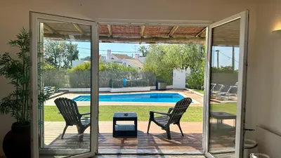 a patio with two chairs and a pool at Galo by Check-in Portugal in Albufeira