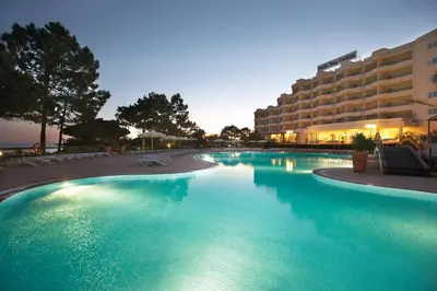 an overhead view of a swimming pool with umbrellas and chairs at PortoBay Falesia in Albufeira