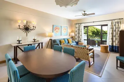 a living room with a table and chairs at Pine Cliffs Residence, a Luxury Collection Resort, Algarve in Albufeira