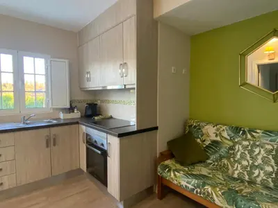a kitchen with a couch and a sink in a room at Quinta das Amendoeiras in Albufeira
