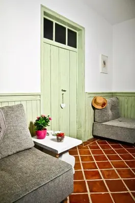 a living room with a couch and a table and a door at Quinta das Amendoeiras in Albufeira