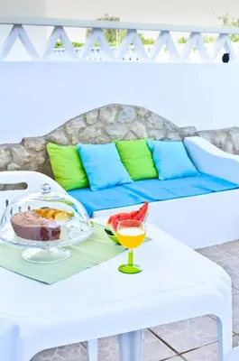 a table with a plate of food and a drink on it at Quinta das Amendoeiras in Albufeira