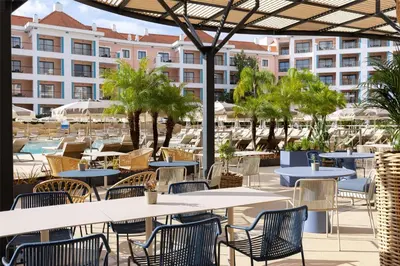 a bedroom with a bed and a living room at Hilton Vilamoura in Vilamoura