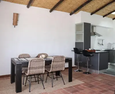 a dining room table and chairs in a kitchen at Quinta Do Mel in Albufeira