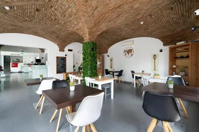 a restaurant with tables and chairs and a green wall at KR Hotels - Albufeira Lounge in Albufeira