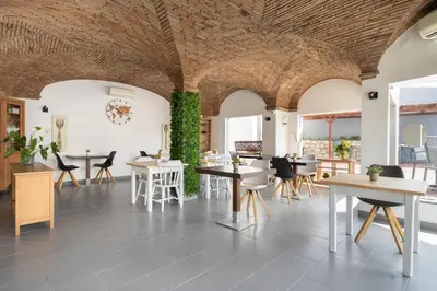 a dining room with tables and chairs and ivy at KR Hotels - Albufeira Lounge in Albufeira