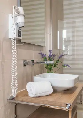 a bathroom with a white sink and a mirror at Casa Mar d'Alma - 100m from the Beach in Albufeira