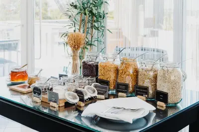 a glass table with jars of food on it at Velamar Boutique Hotel - Adults Friendly in Albufeira