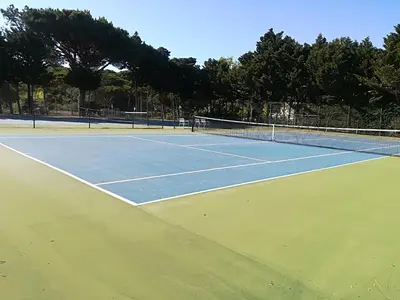 a tennis court with two tennis courts at Victory Village Club 9F in Quinta do Lago