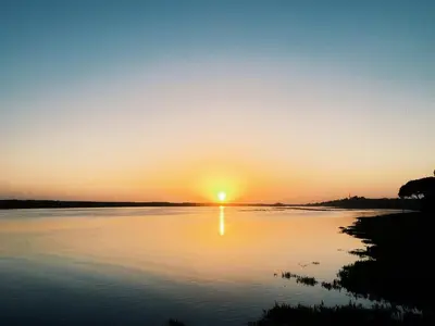 a sunset over a body of water at Victory Village Club 9F in Quinta do Lago