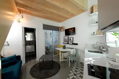a living room with a blue couch and a table at Dubocage45Citycenter in Faro