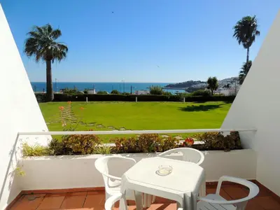 a balcony with a table and chairs and a view of the ocean at Almar Hotel Apartamento in Albufeira