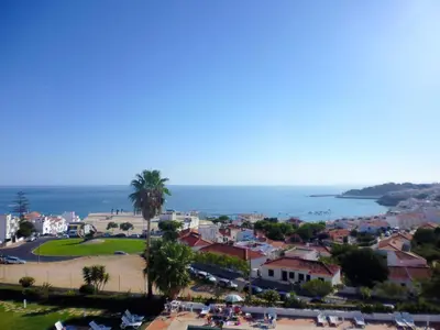 a view of a town with the ocean in the background at Almar Hotel Apartamento in Albufeira
