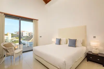 a living room with a couch and a staircase at Vale Do Lobo Resort in Vale do Lobo