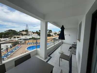 a balcony with a view of a swimming pool at Apartamentos Do Parque in Albufeira